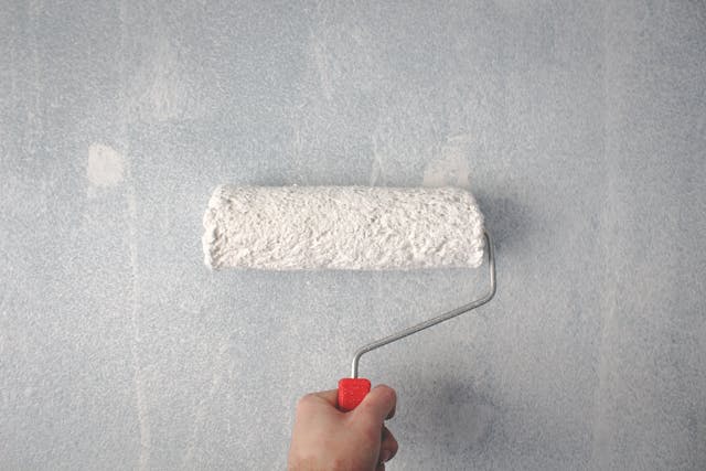 a%20white%20painting%20roller%20on%20a%20wall